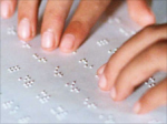 female hands on braille